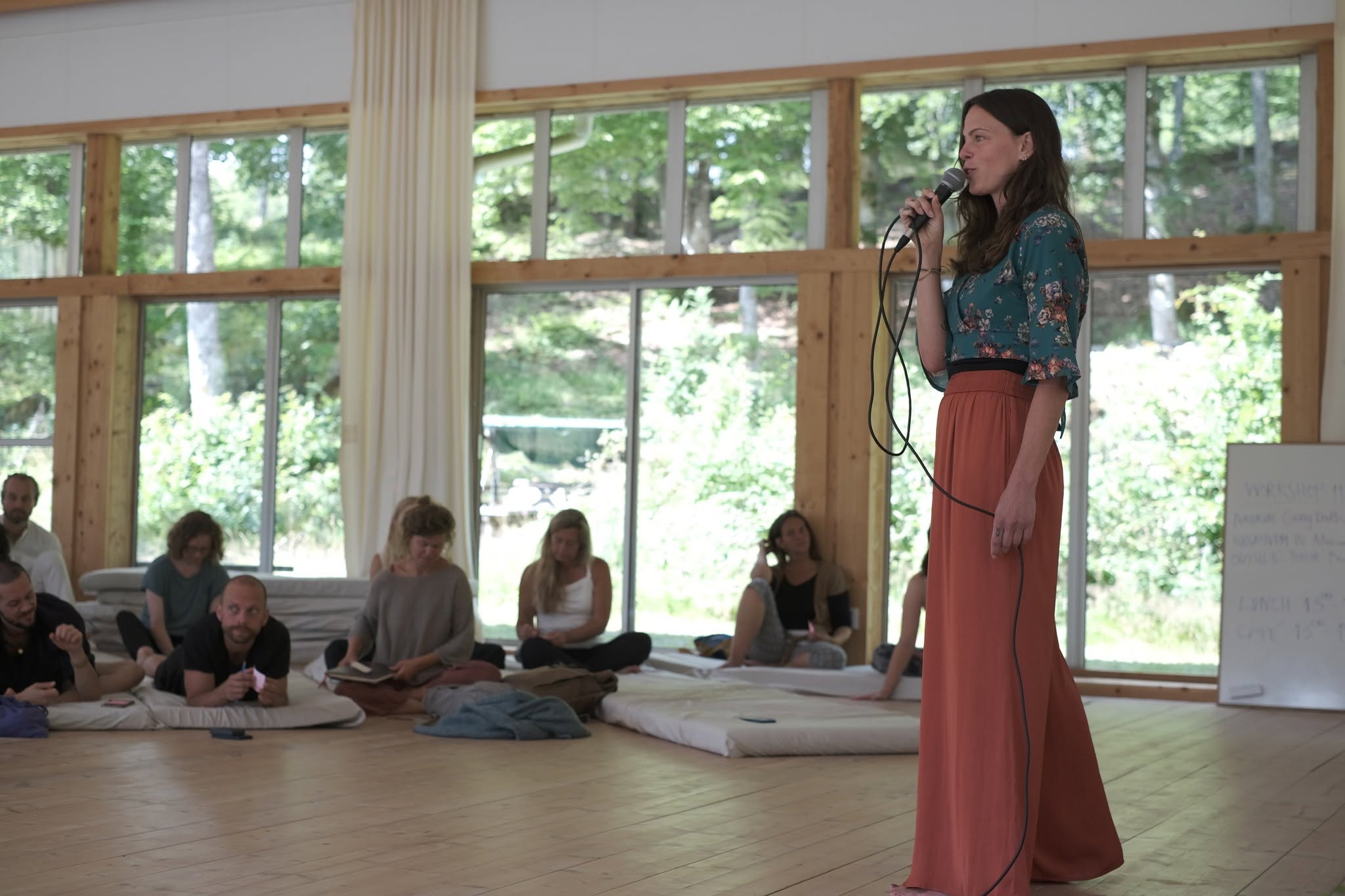 Sandra speaking to a seated group during a workshop